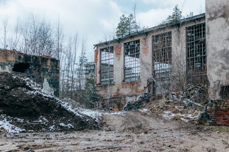 a very large building next to some trees and dirt