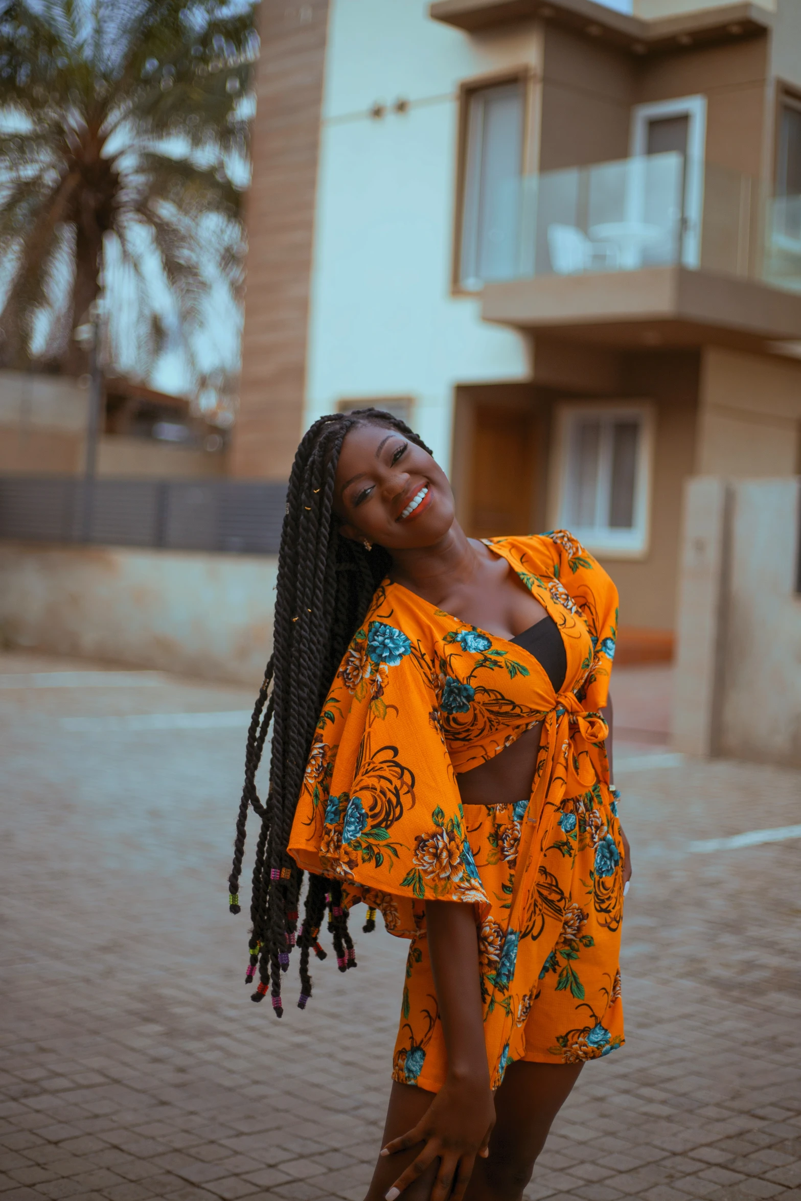 a smiling woman in an orange floral kimono