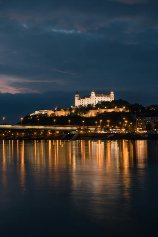 the city is seen from across the water at night