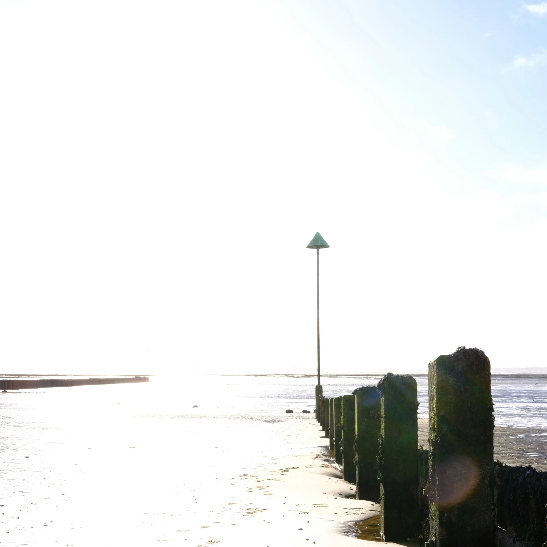 a street light near the shore during the day