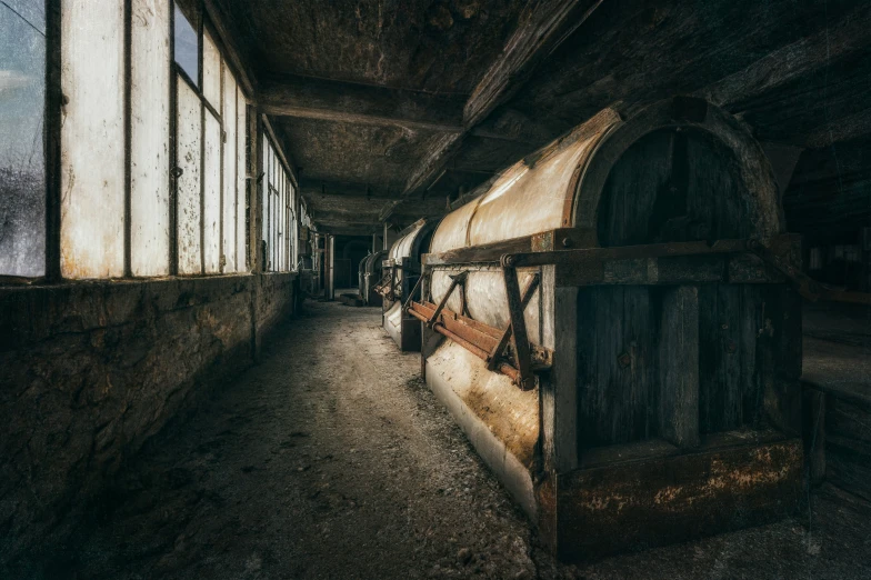 an empty long hallway with some benches sitting next to it