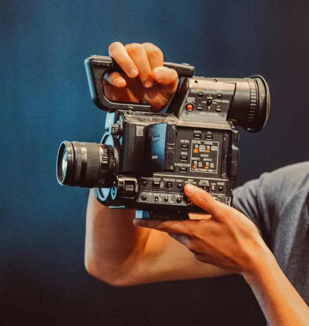 an image of man holding up a camera