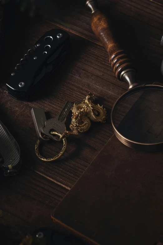 a pair of glasses, key chains and an alarm clock on top of a table