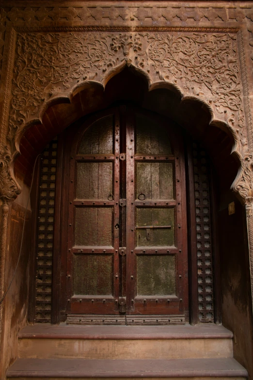 a brown and tan doorway with intricate carved designs