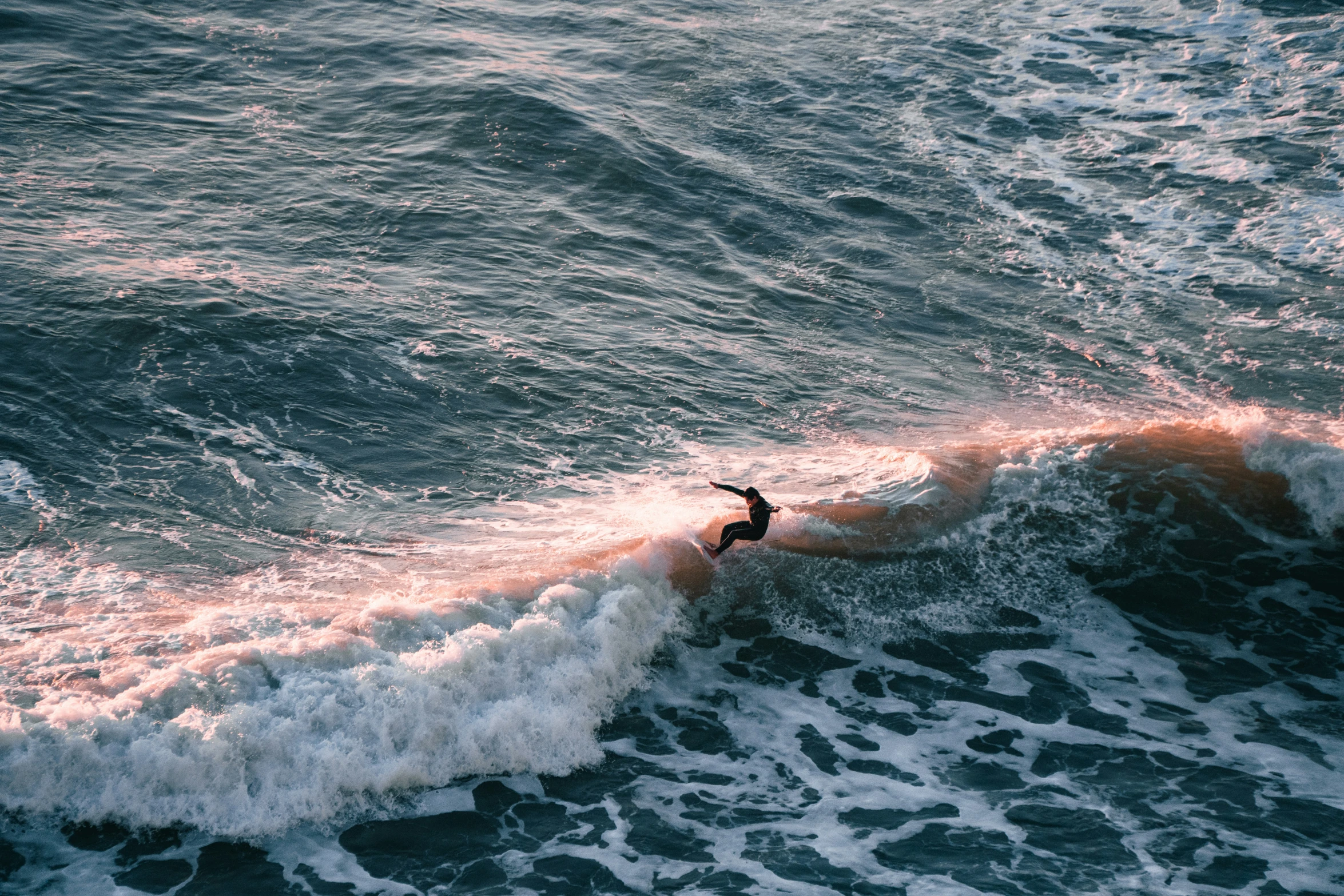 a person surfing in the ocean on the waves