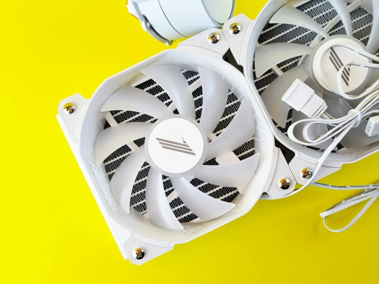 two white fan attached to the front of a laptop