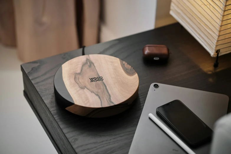 a cell phone and laptop next to a wooden surface