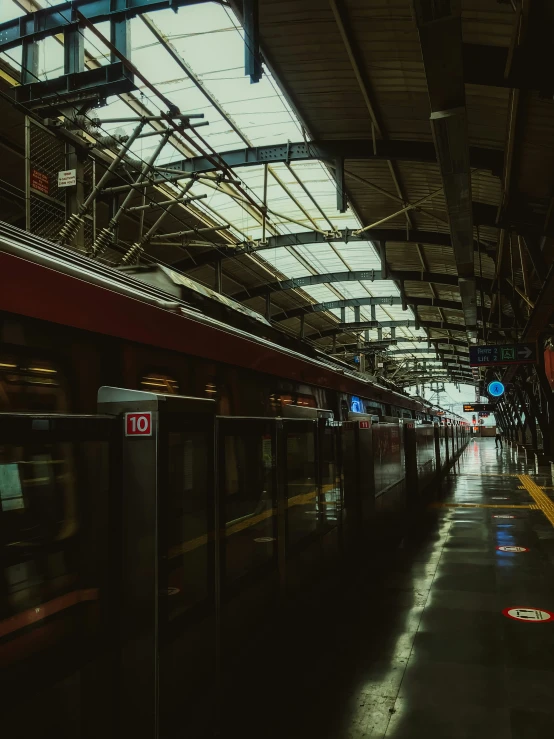 this train station has two sets of doors and glass ceilings