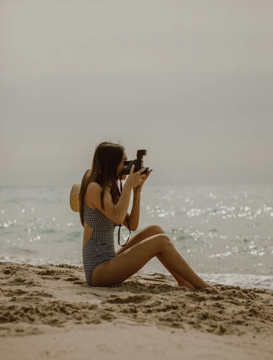 the woman is taking her own picture on the beach