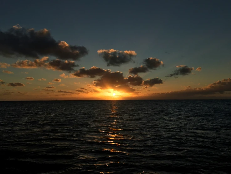 a picture of the sun setting over the ocean