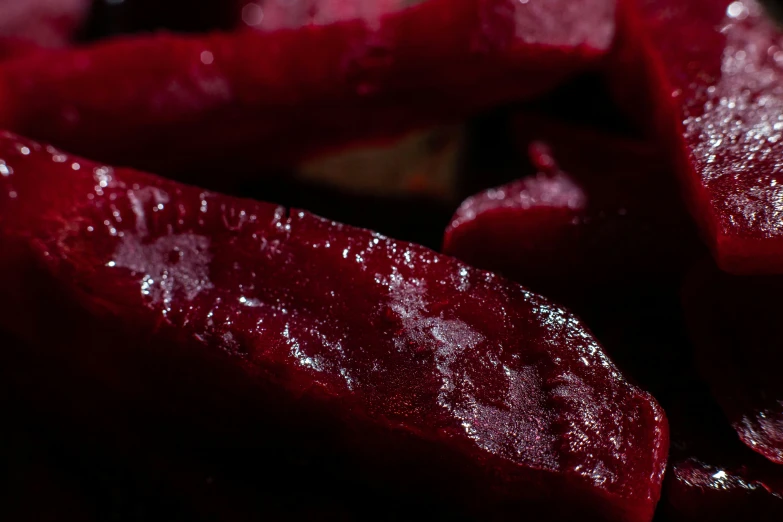 sliced red beets sit on top of a table