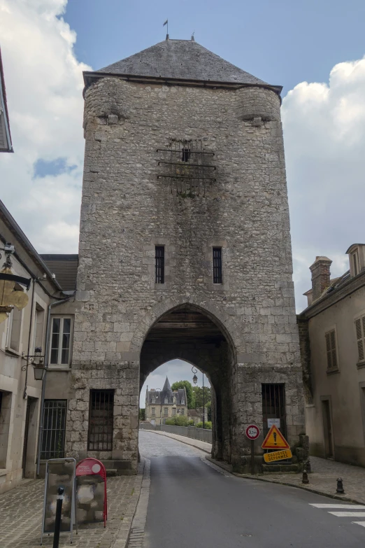 an old stone building with an archway between two buildings