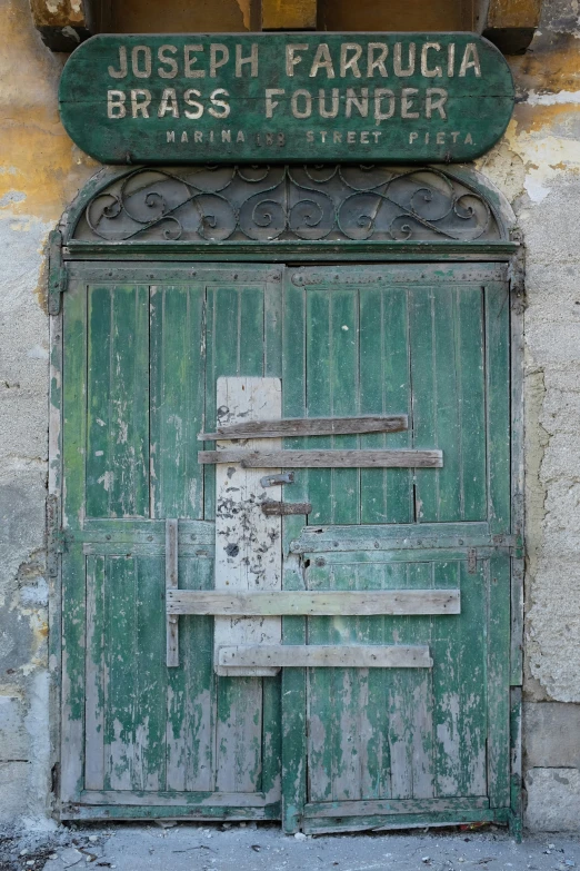 an old wooden door has graffiti on the side