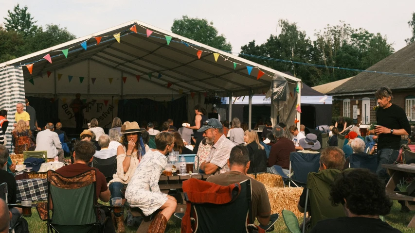 group of people at outdoor event with banners over them