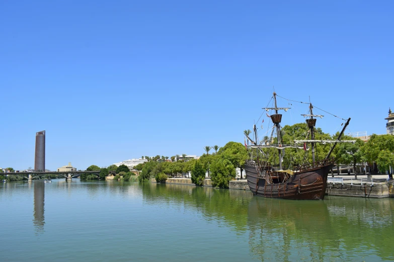 a ship sitting on the water near a dock