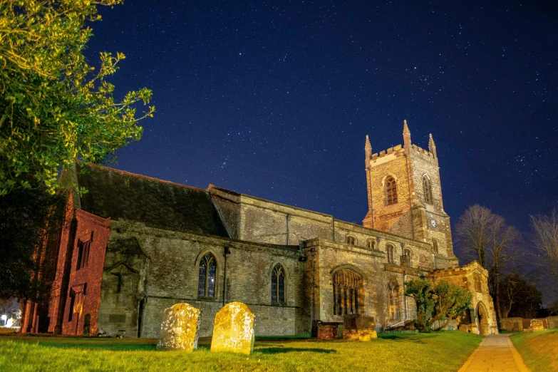 an old church that has its lights on during the night