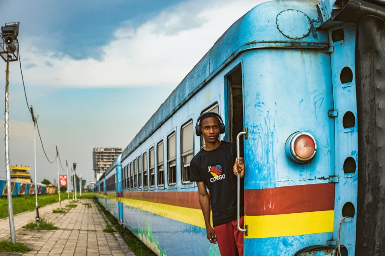 a man standing next to a colorful train