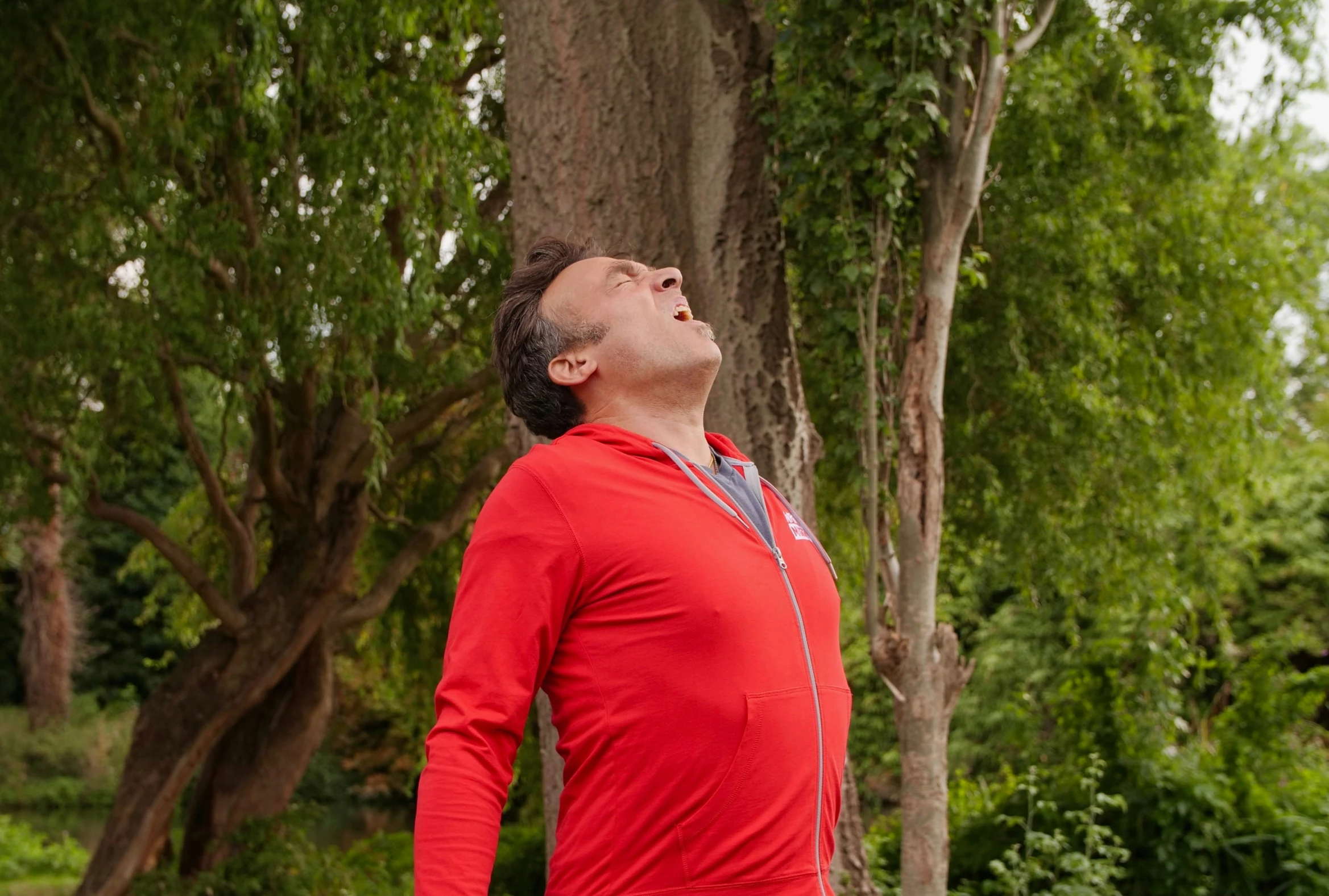 a man is standing outside while looking up