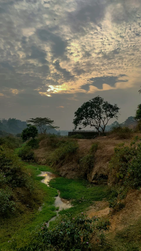 a very pretty landscape with a creek in the middle