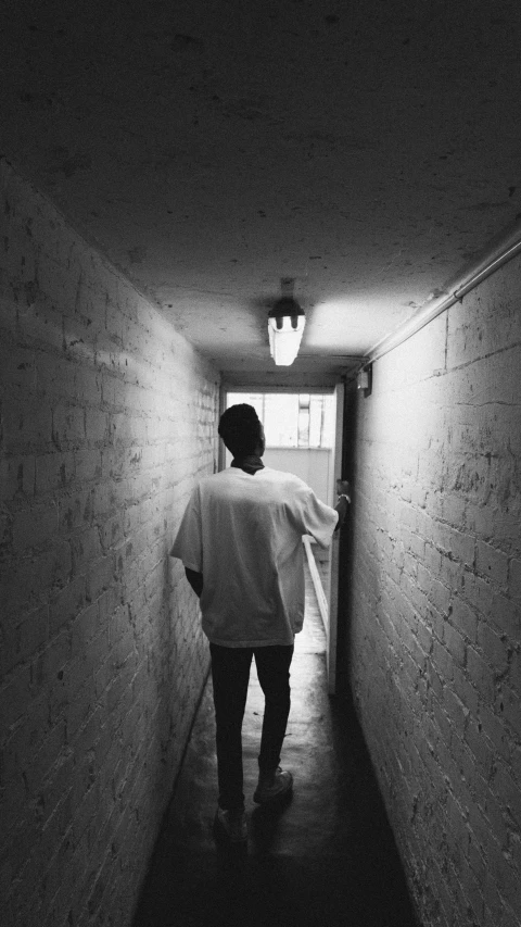 a person is walking down a dark hallway