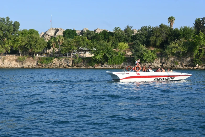 two people are riding on the front of a boat