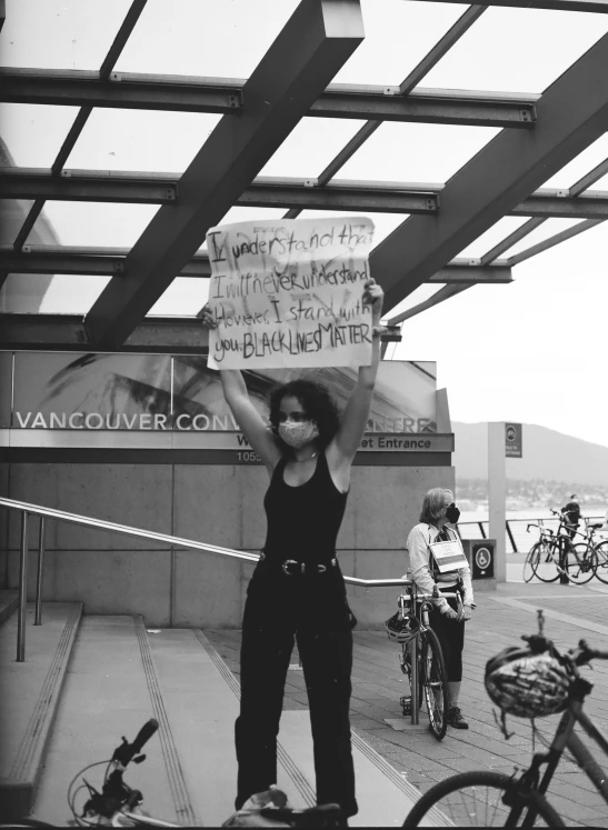 a woman holding up a sign over her head