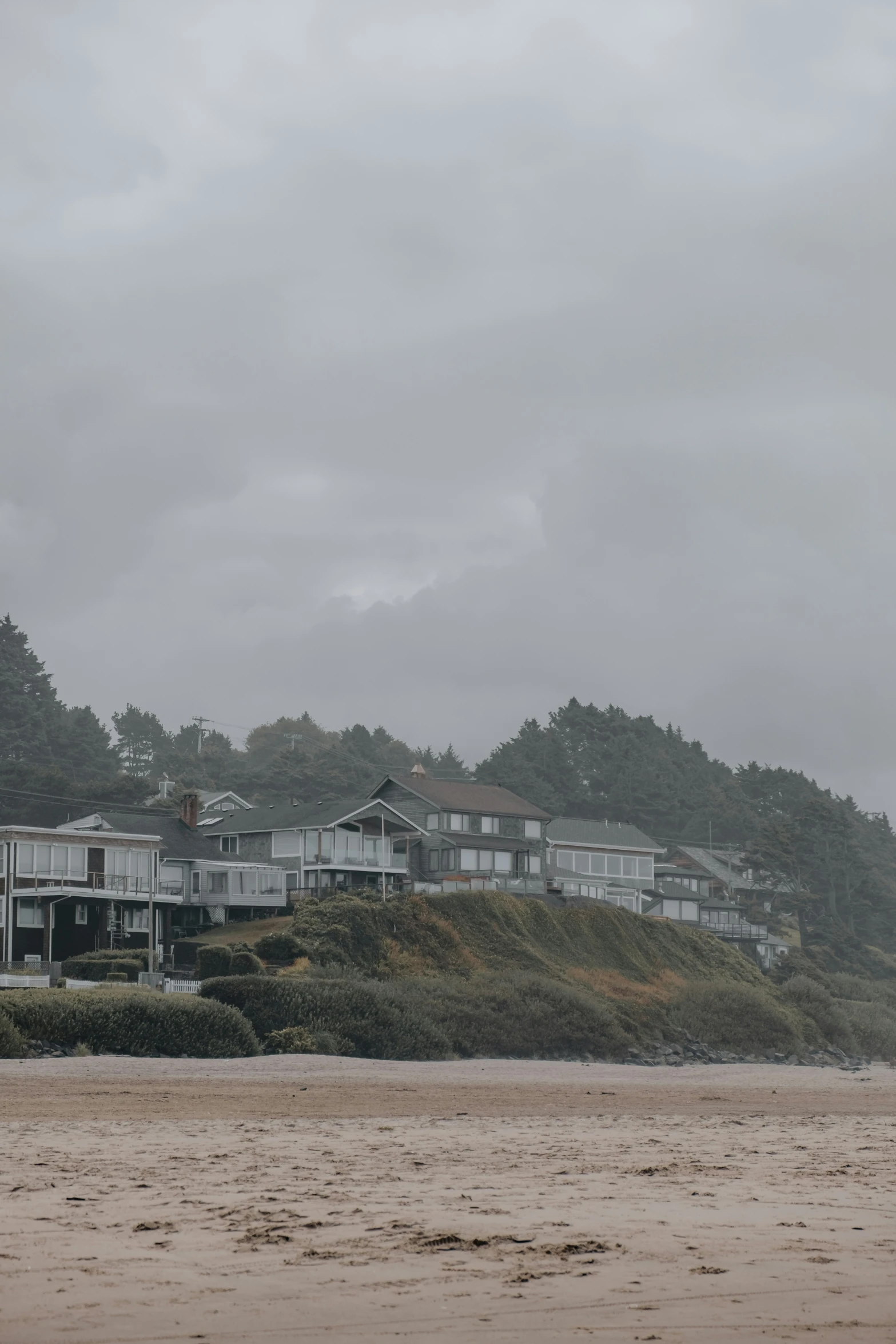 a row of wooden buildings overlooks the beach