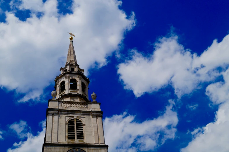 a steeple in the middle of cloudy sky