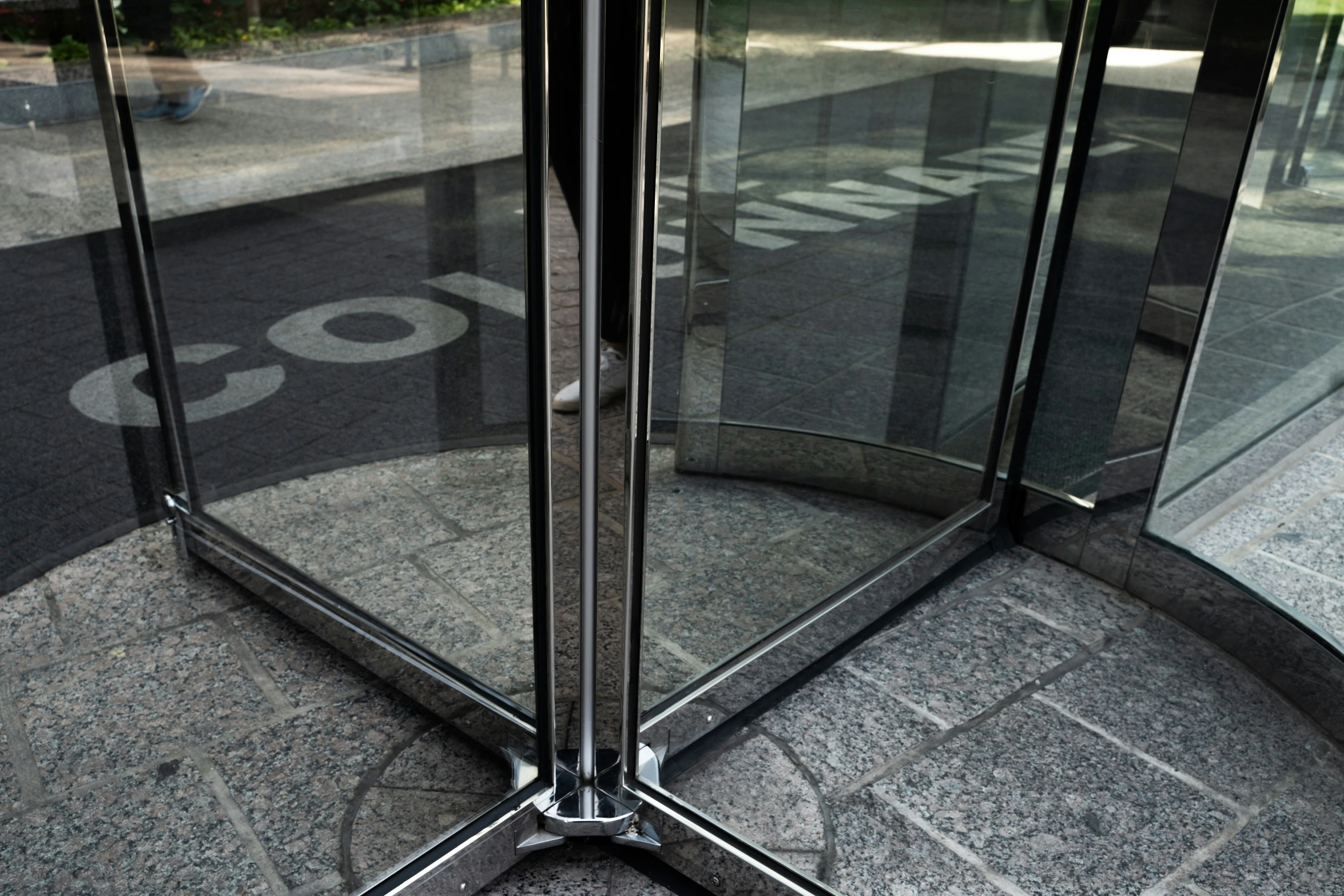 the round glass entrance to a parking garage