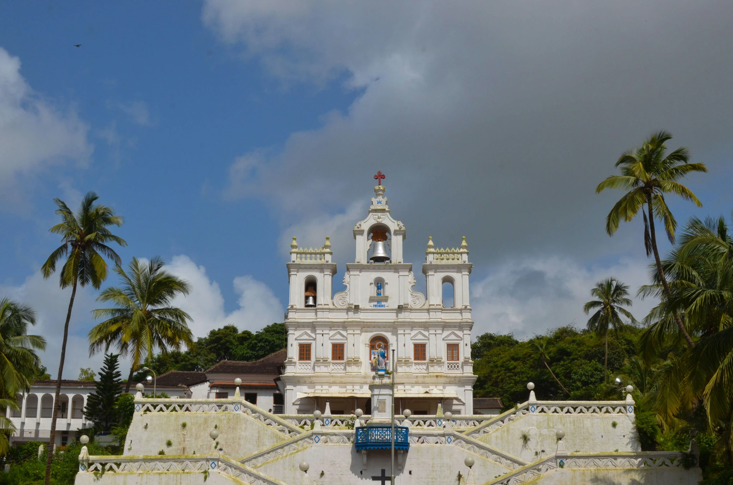 a large white church is built into the mountain