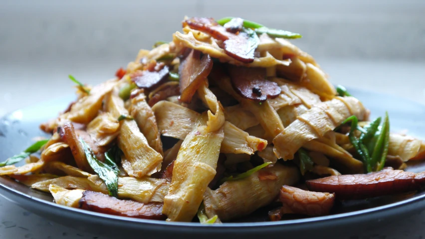 a large pile of pasta sitting on top of a white plate