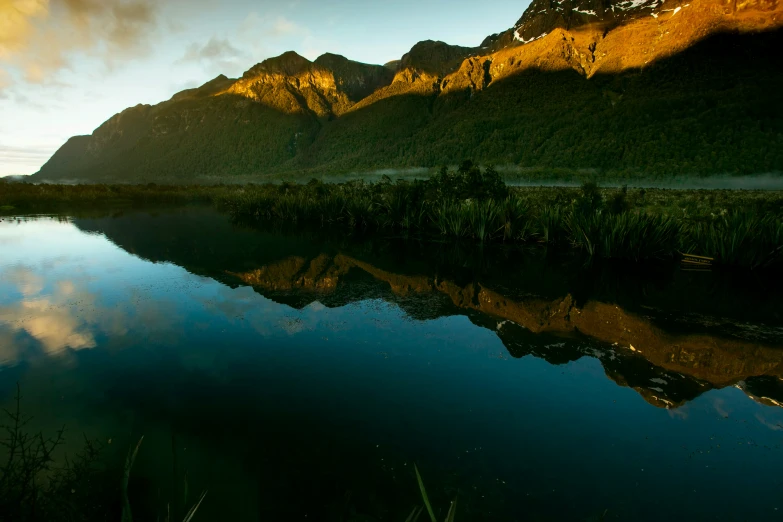 mountains reflect the early morning light as the sun rises