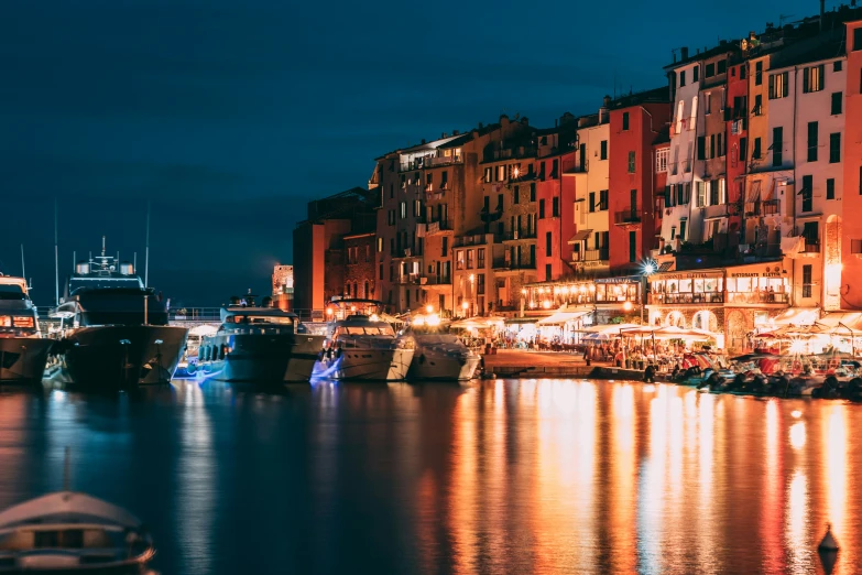 several buildings next to water at night