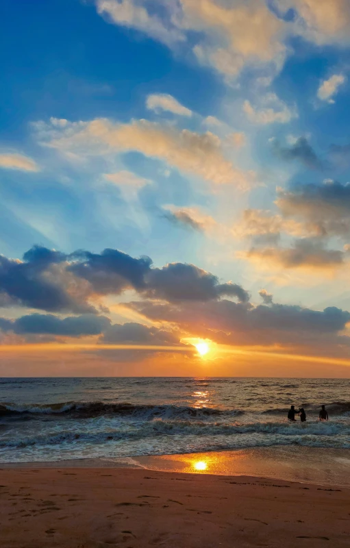 people are standing on the beach and surfing