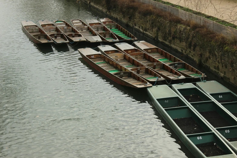 several canoes are lined up next to the water