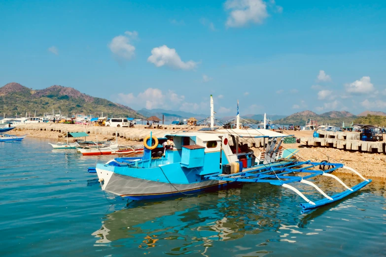 several boats docked near the shore of a beach