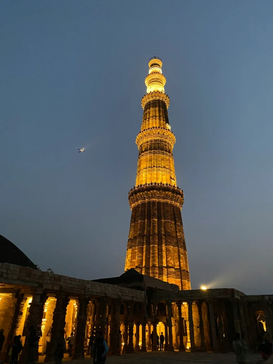 a tall tower illuminated up with lights at night