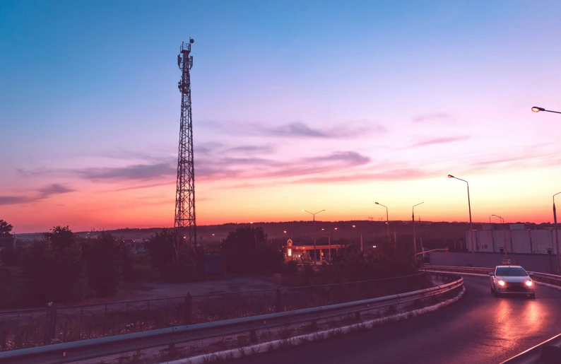 a bus is traveling down the road at dusk