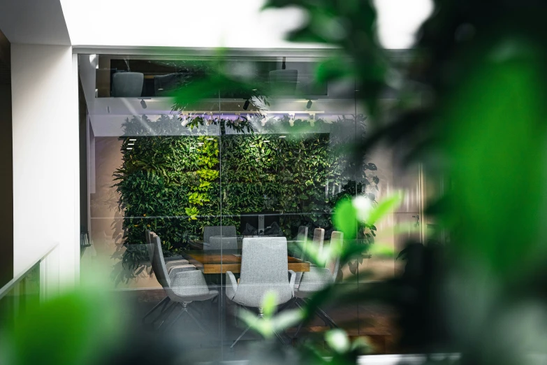 a balcony with green plants and white chairs