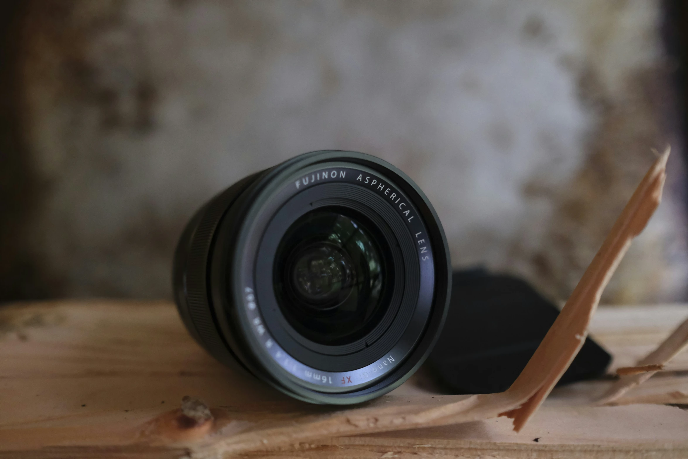 an old camera with a wood stick sitting on top of it