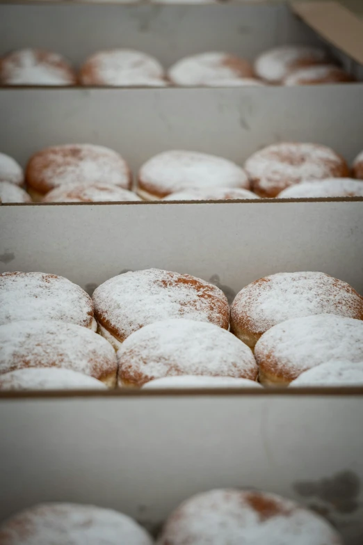 some very pretty trays filled with some sugar covered doughnuts