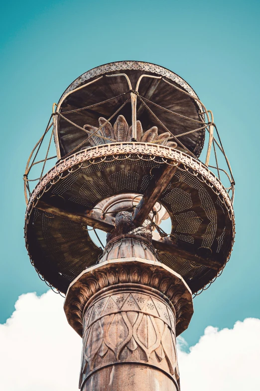 a bird nest in a metal structure on a cloudy day