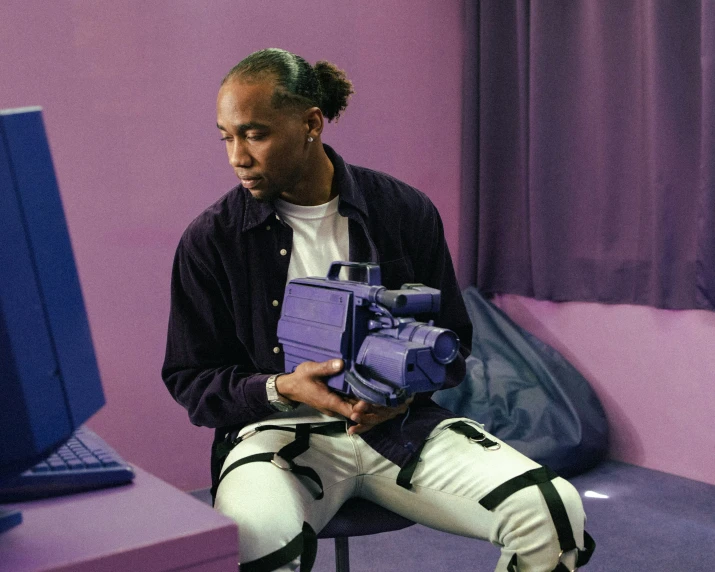 a person sitting in a chair with a purple box