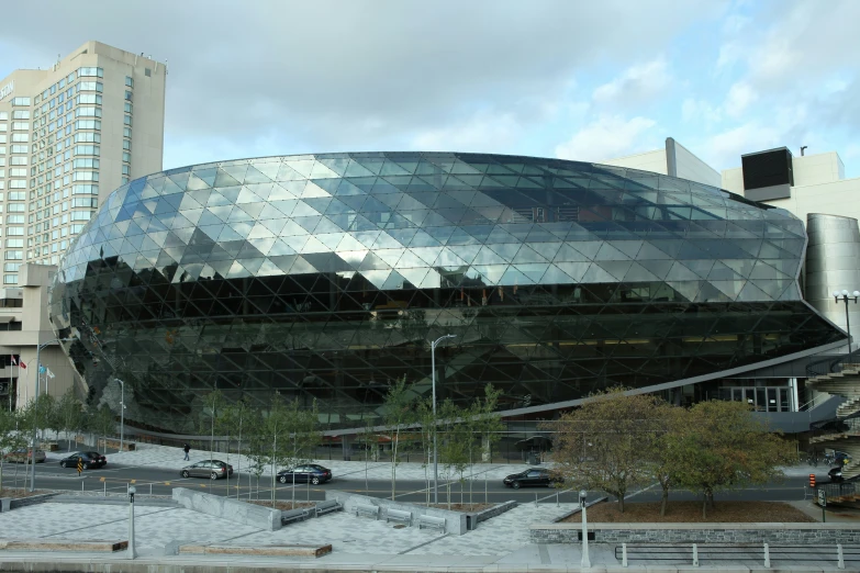 a large, modern looking building with a big face in front