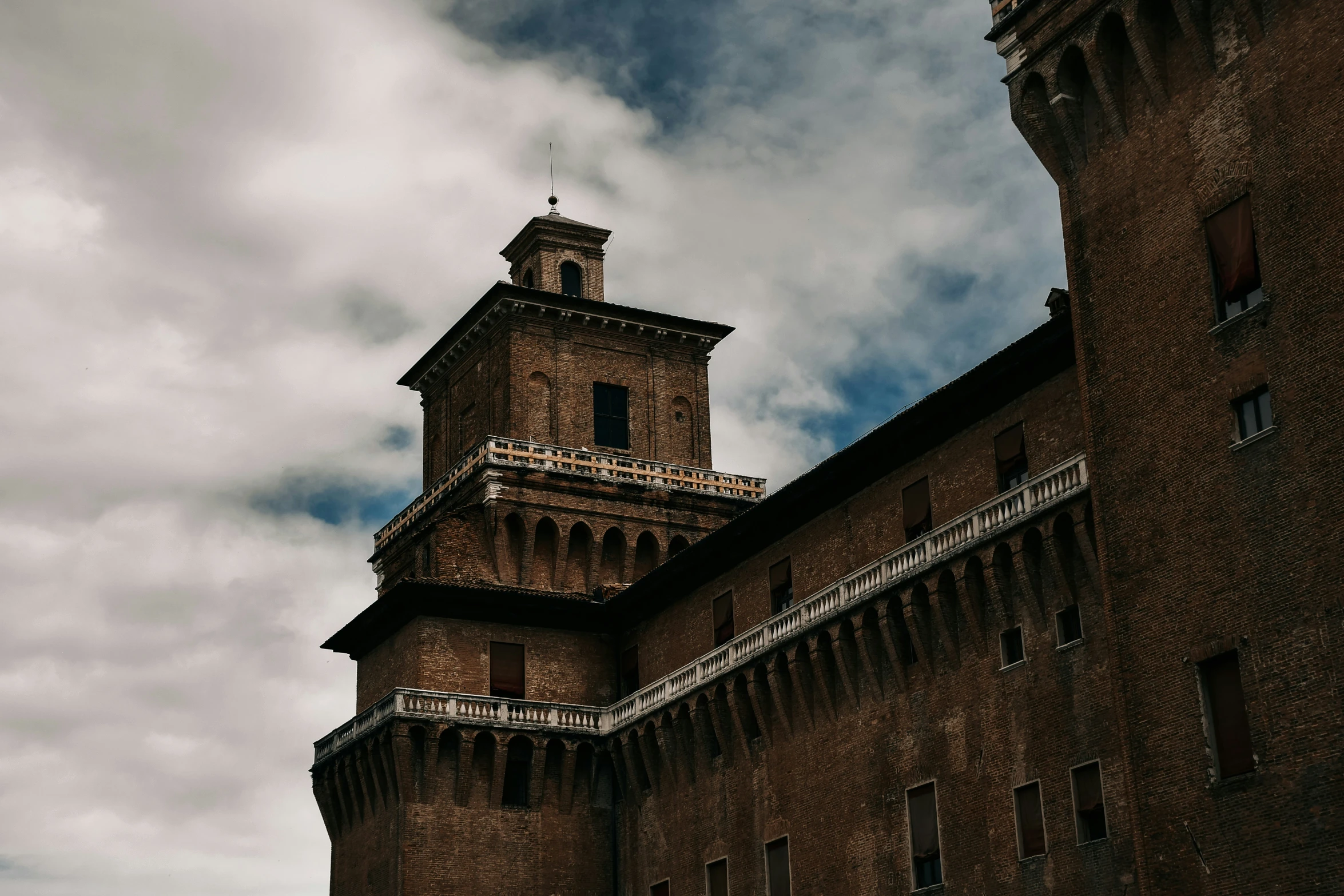 a very tall brick building with a clock tower