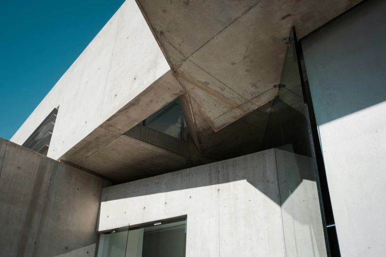 a very interesting concrete structure and windows and sky