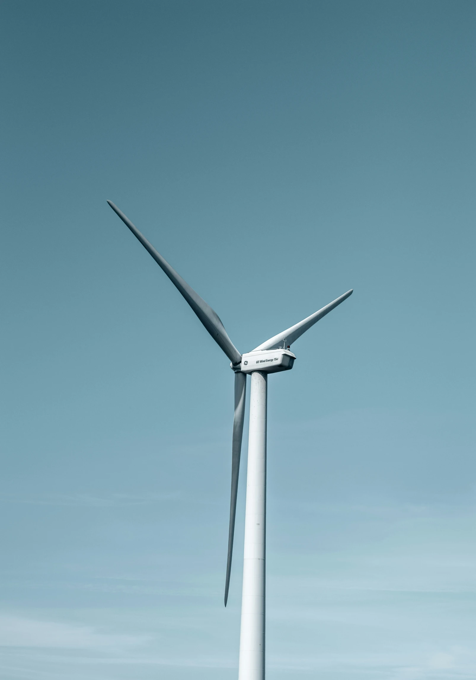 large windmill in front of blue sky on a sunny day