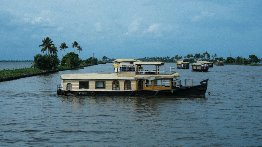 a house boat is cruising along a river