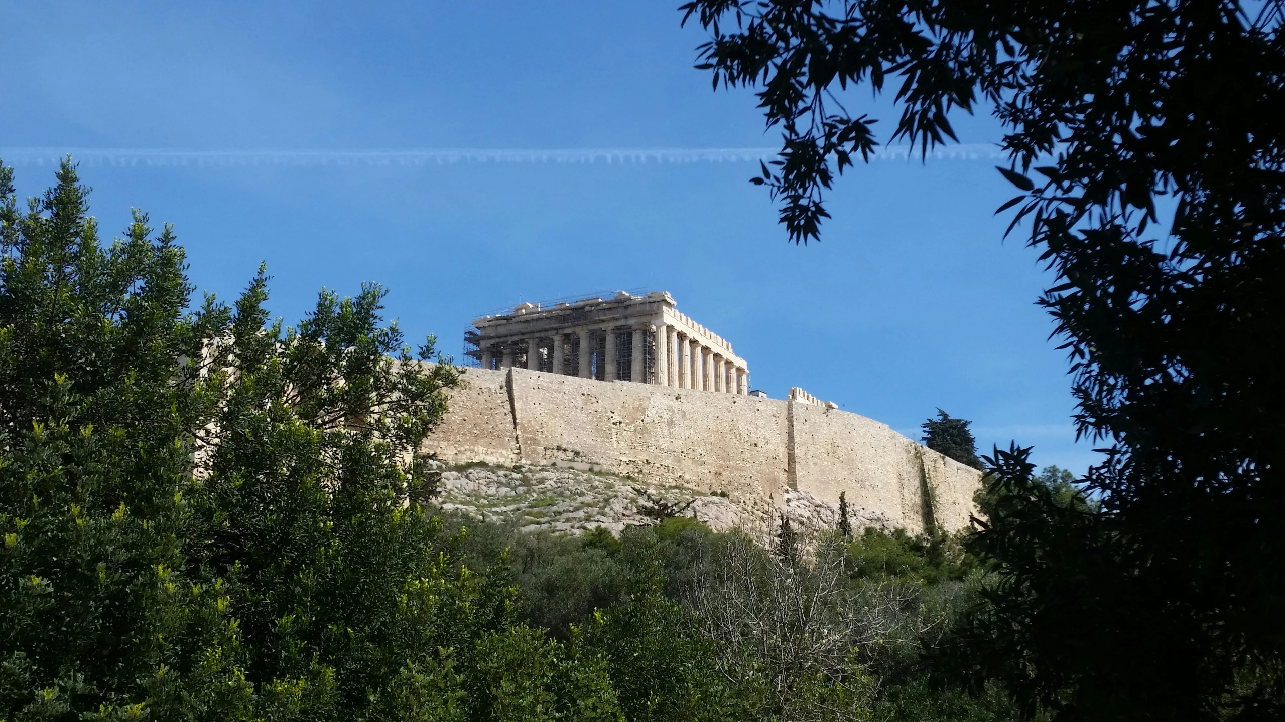 the acrobatic ruins are seen through the trees