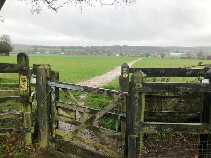 a couple of gates leading into a lush green field